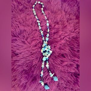 Turquoise color rope necklace.